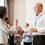 Two people shaking hands - how to build trust in a workplace relationship.