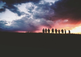 People standing together at sunset